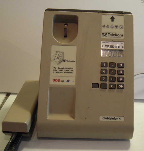 A telephone seen from the front against a white background.
	The handset is off-hook.