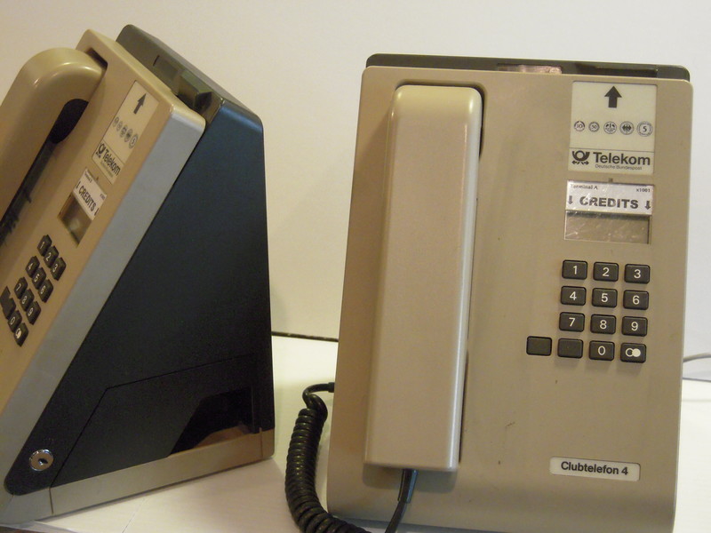 Two wedge-shaped telephones against a white background.
	The one at right is seen from the front, and the one at left is turned to face partly left.