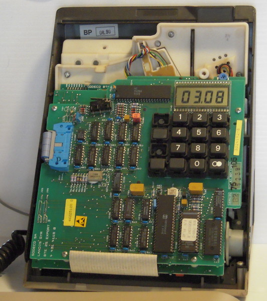The same telephone, but with the front panel removed to expose the circuit boards
	and other components inside.