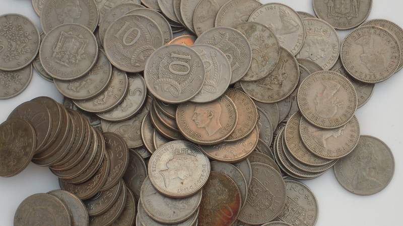 A pile of mostly British and Commonwealth coins, enumerated in the list below